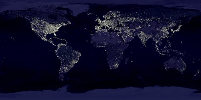 12 Laws of the Universe - Satellite view of Earth at night with illuminated cities across continents.