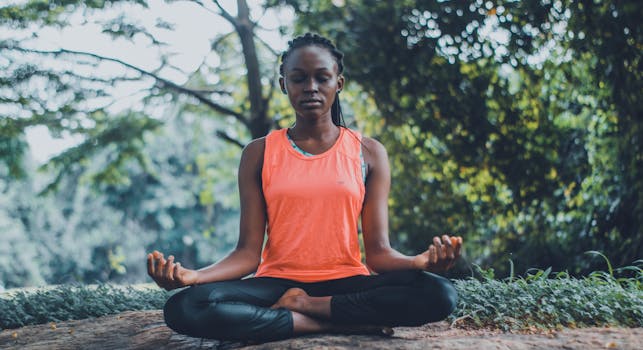 Spirituality and Law of Attraction - A woman meditating peacefully outdoors in a lush green setting, promoting relaxation and mindfulness.