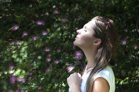 Manifestation Challenges - A woman enjoying a serene moment in a sunlit garden, surrounded by vibrant flowers.