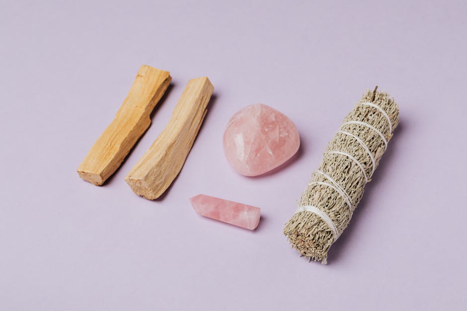 Rose quartz and sage arrangement on lavender backdrop, ideal for meditation and rituals.