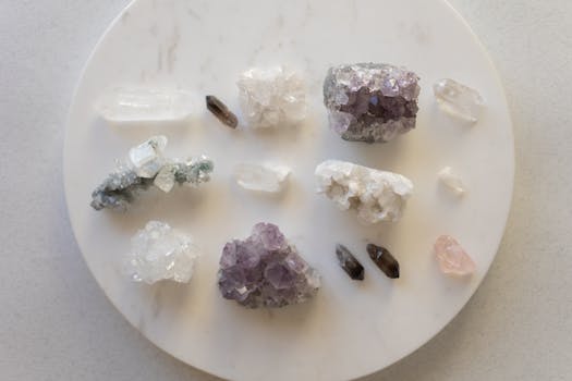 Manifesting with Crystals - A top view of various healing crystals on a marble surface, showcasing natural beauty.