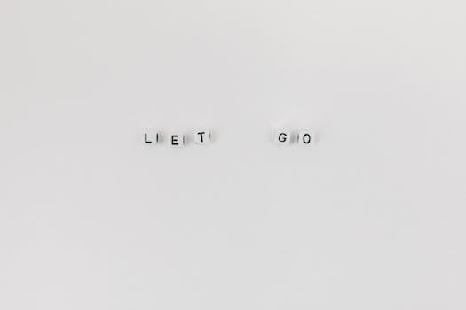 Law of Attraction: How to Let Go - Minimalist composition featuring 'Let Go' spelled with letter dice on a clean white background.