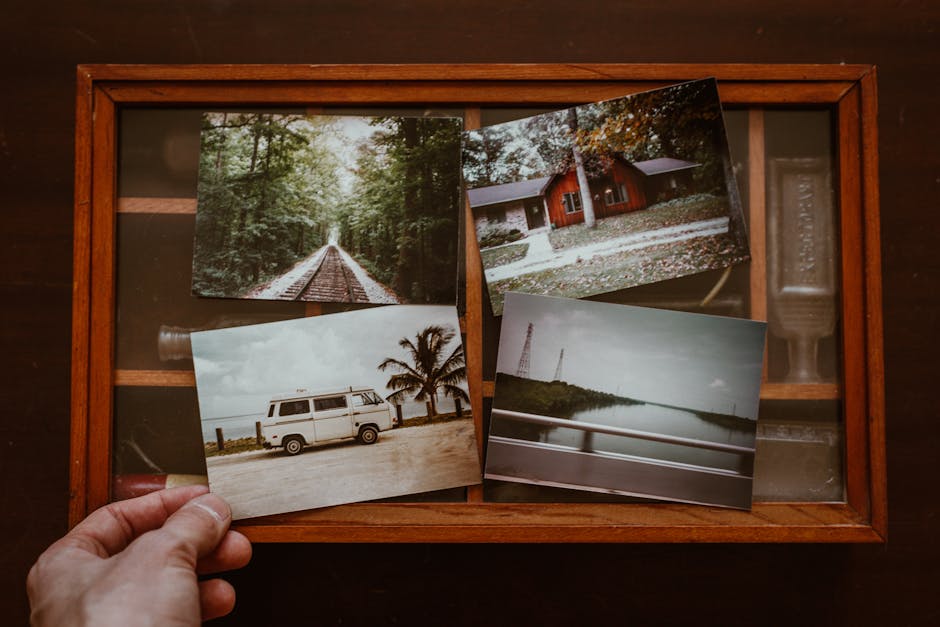 A collection of nostalgic vintage photographs in a wooden box, evoking travel memories.