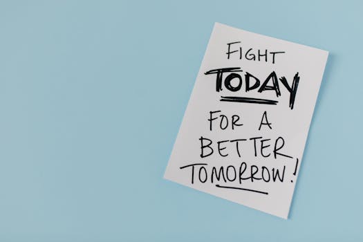 How to Create a Vision Board for Manifestation Effectively How to Create a Vision Board for Manifestation - Inspirational handwritten message urging action for a better future on paper over a blue backdrop.