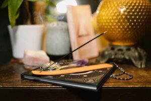 A tranquil setting featuring incense, crystals, and a glowing lamp for spiritual rituals.