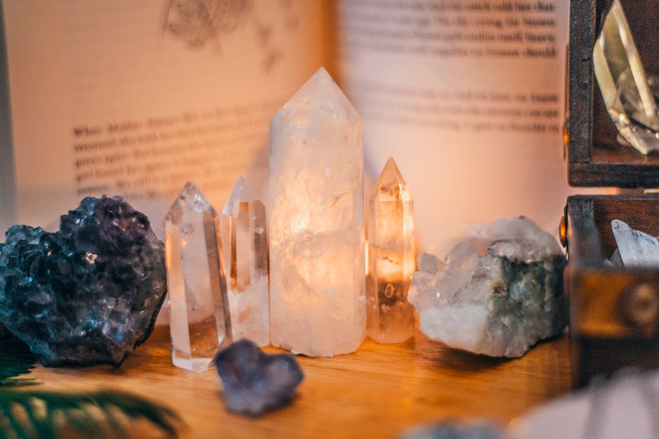 Manifesting with Crystals - Close-up of various healing crystals on a wooden table with warm lighting