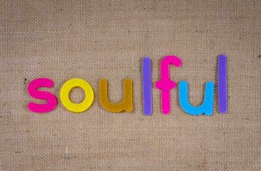 Spirituality and the Law of Attraction -Vibrant letters spelling 'soulful' on textured burlap, highlighting creativity.