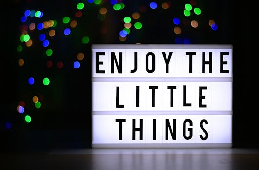 How to raise your vibration - Lightbox displaying 'Enjoy the Little Things' against a colorful bokeh backdrop for inspiration.