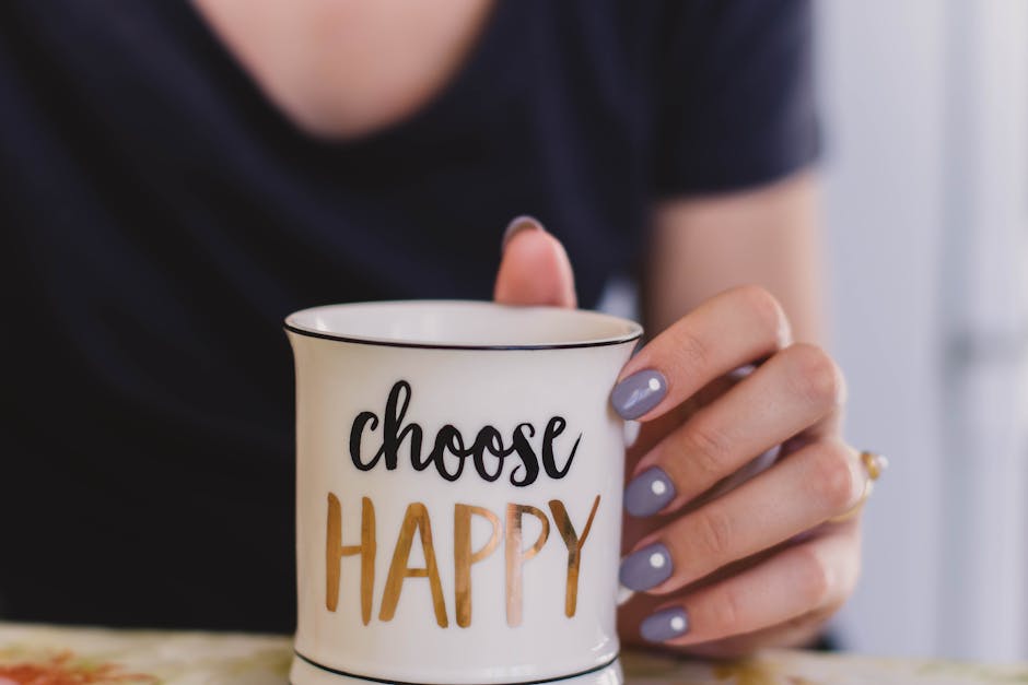 Gratitude and Manifestation: Using Gratitude To Manifest A woman holds a mug with 'choose happy' text indoors, promoting positivity.